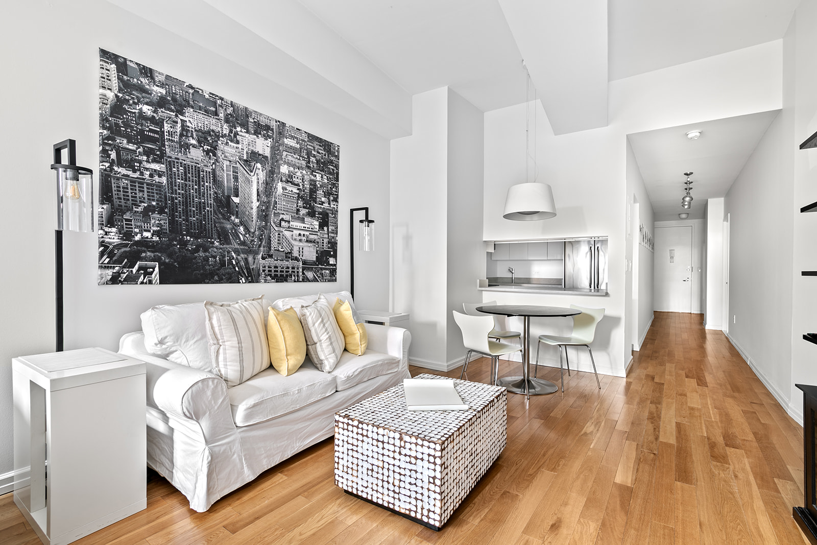 99 John Street, Unit 522 Manhattan, NY 10038 - Photo 3 of 11 a living room with furniture and a wooden floor