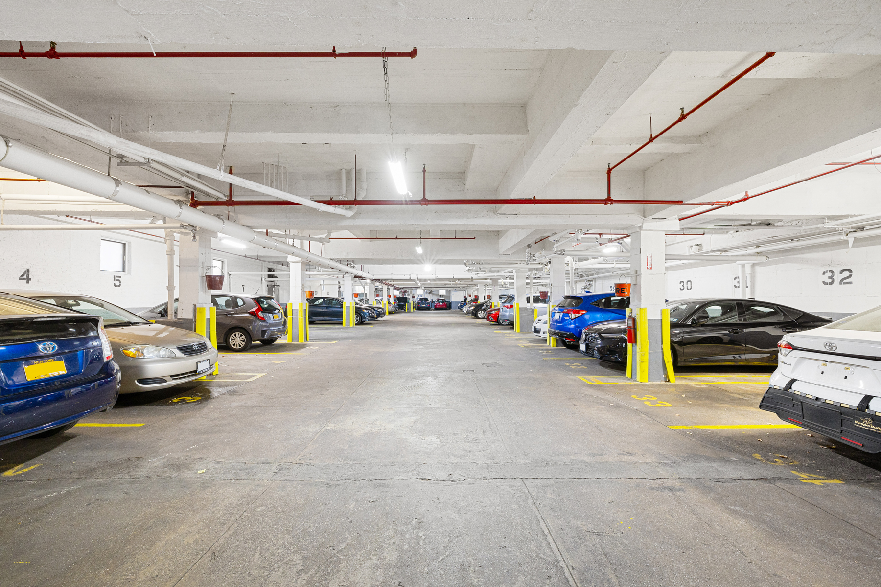 77-11 35th Avenue, Unit 3N Queens, NY 11372 - Photo 20 of 21 a view of parking garage with cars and bicycles