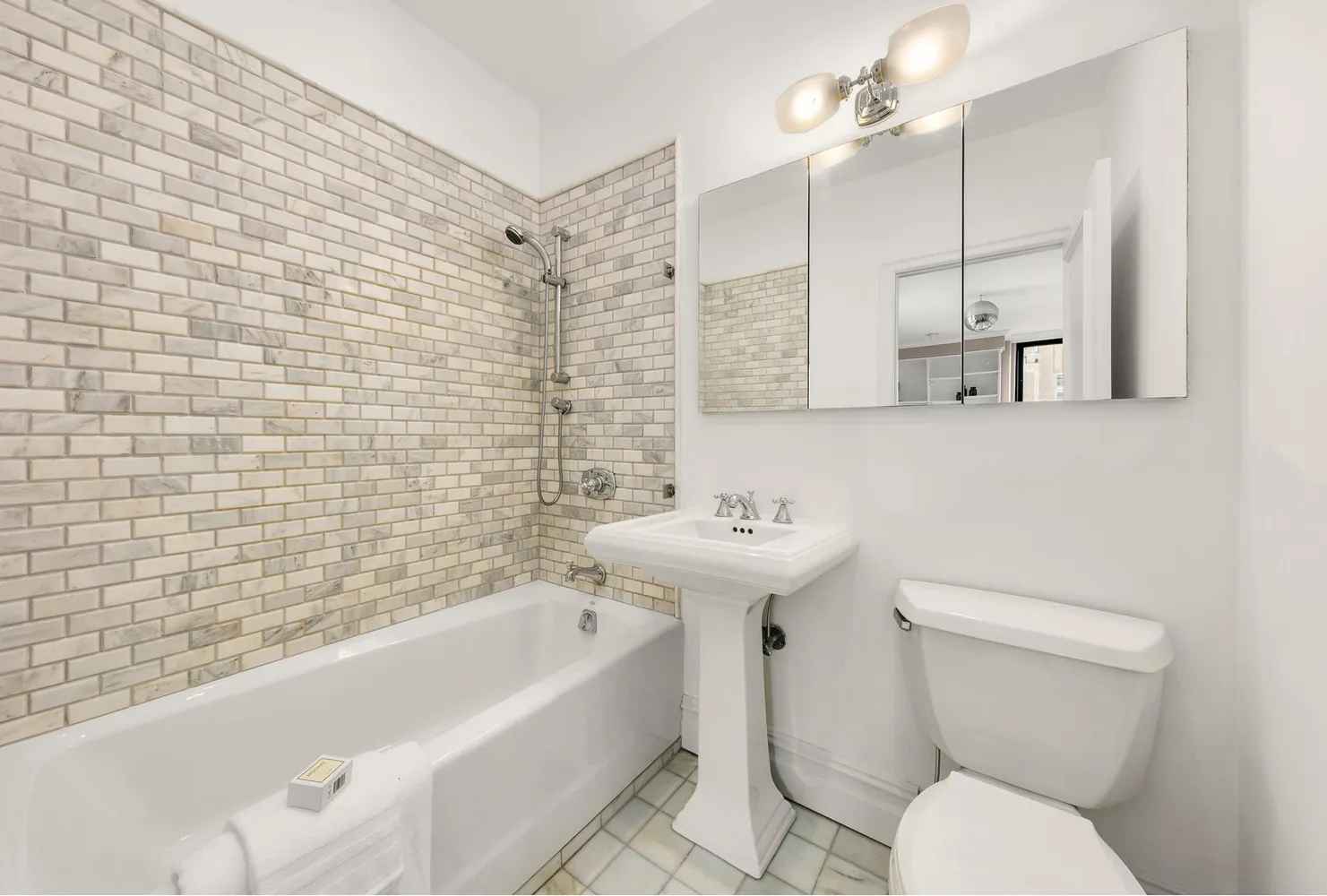 a bathroom with a sink a toilet and bathtub