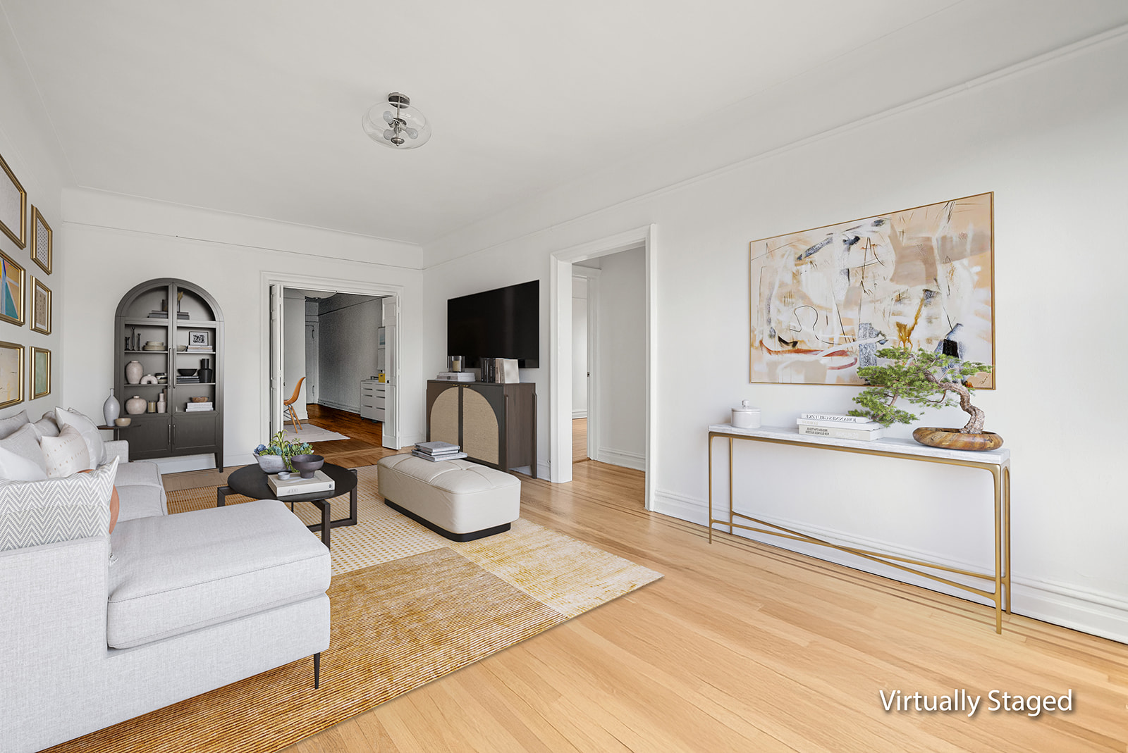 83-10 35th Avenue, Unit 6C Queens, NY 11372 - Photo 2 of 13 a living room with furniture and a flat screen tv