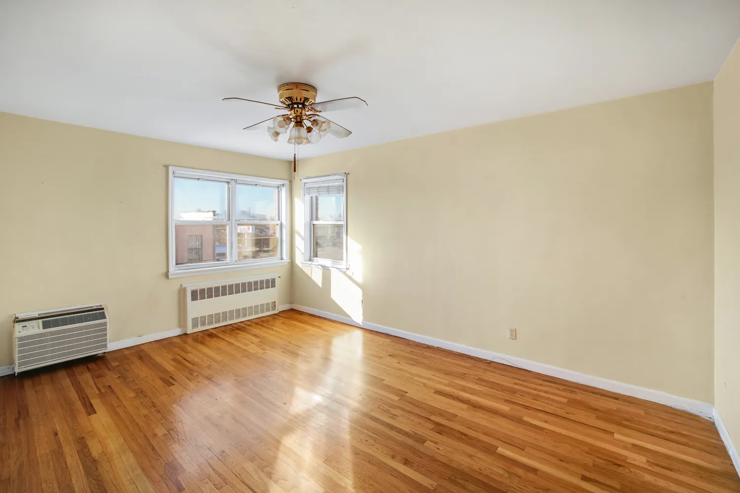 a view of room with a ceiling fan and hardwood floor
