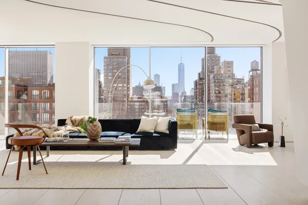 a living room with furniture and large windows