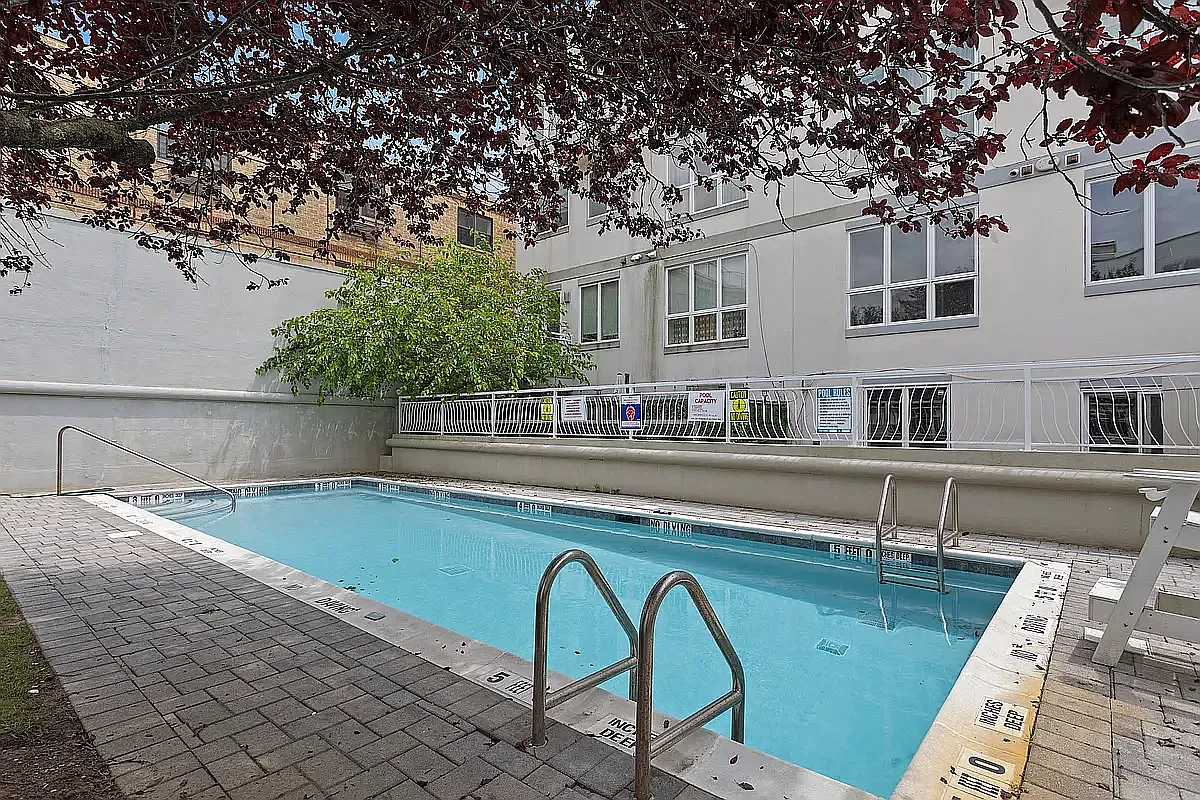 3112 Emmons Avenue, Unit 3132-2 Brooklyn, NY 11235 - Photo 7 of 11 a swimming pool with outdoor seating and yard
