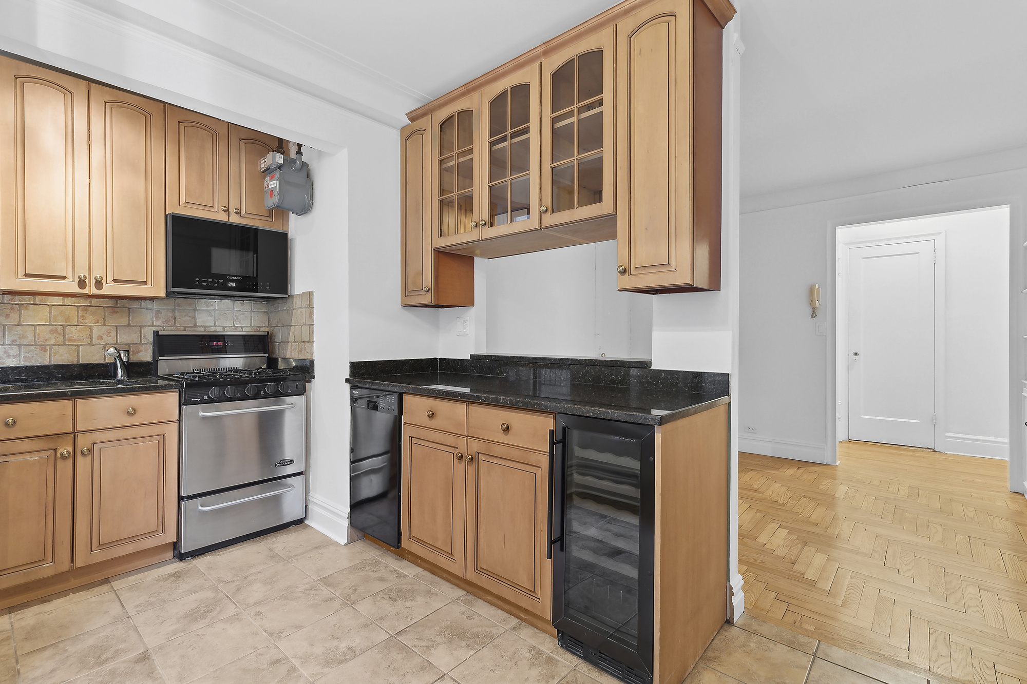 230 West End Avenue, Unit 5B Manhattan, NY 10023 - Photo 3 of 6 a kitchen with stainless steel appliances granite countertop a stove and a sink