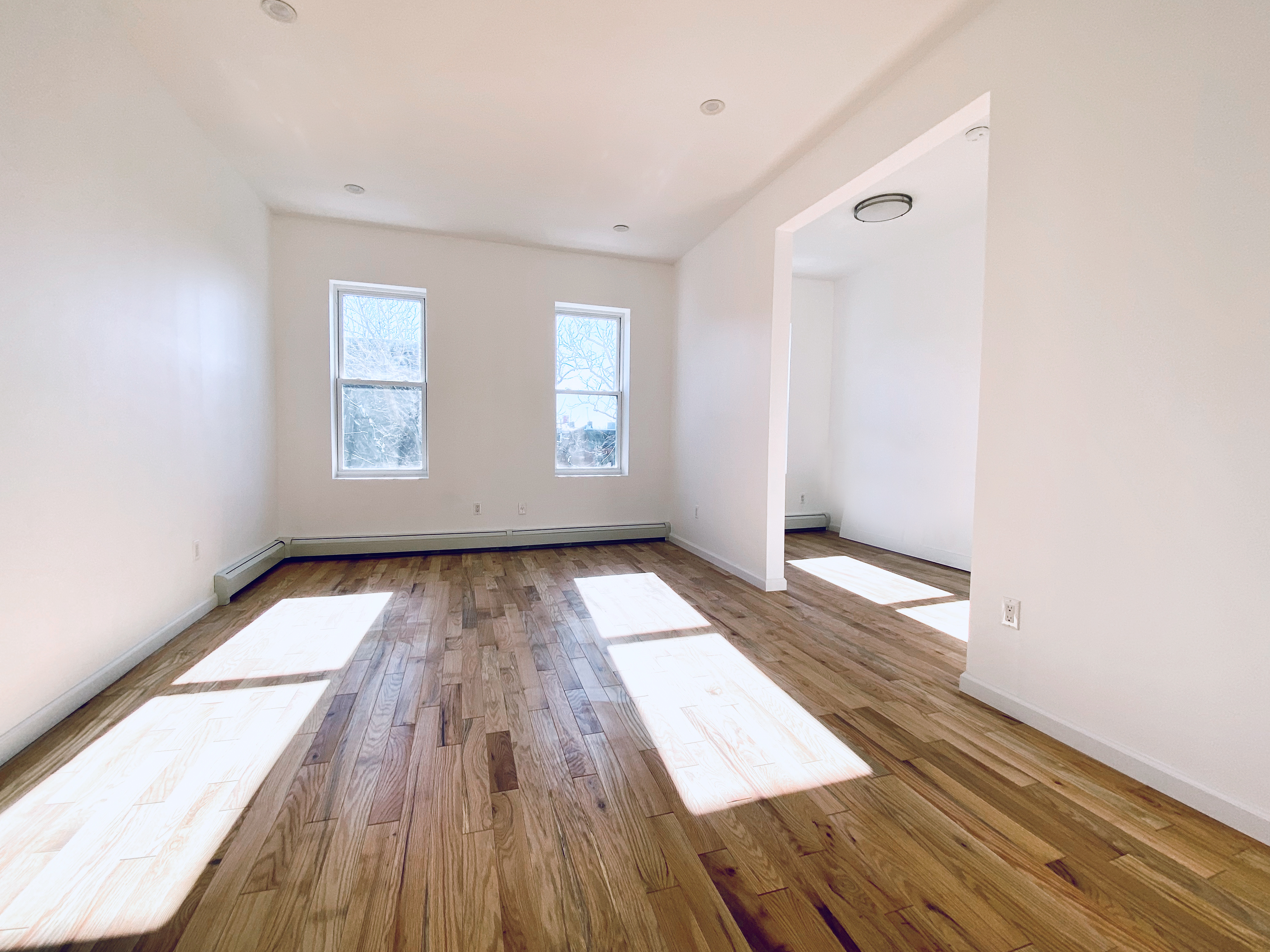 175 Luquer Street, Unit 4 Brooklyn, NY 11231 - Photo 20 of 21 an empty room with wooden floor and windows
