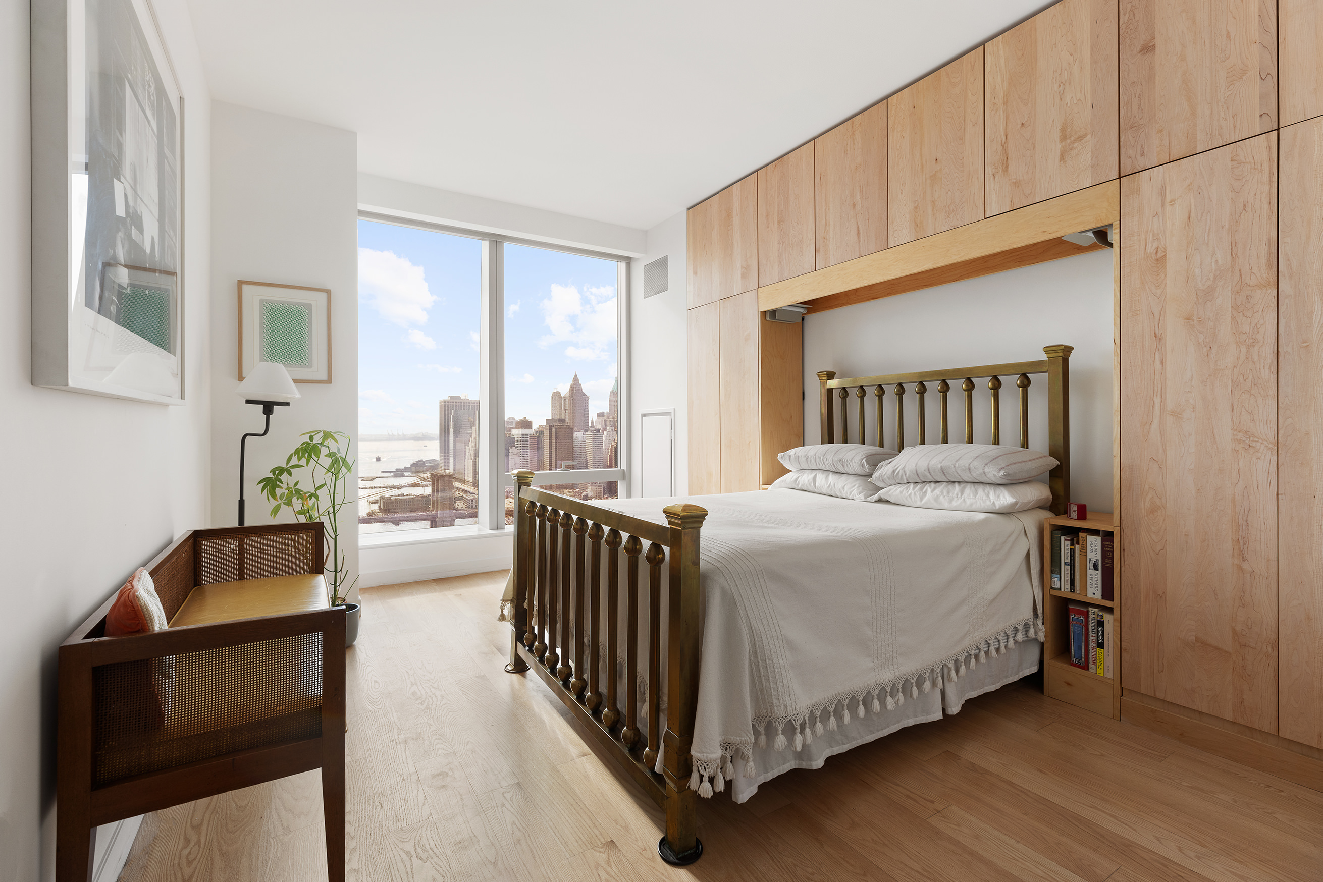 252 South Street, Unit 43C Manhattan, NY 10002 - Photo 5 of 10 a bedroom with a bed and glass windows