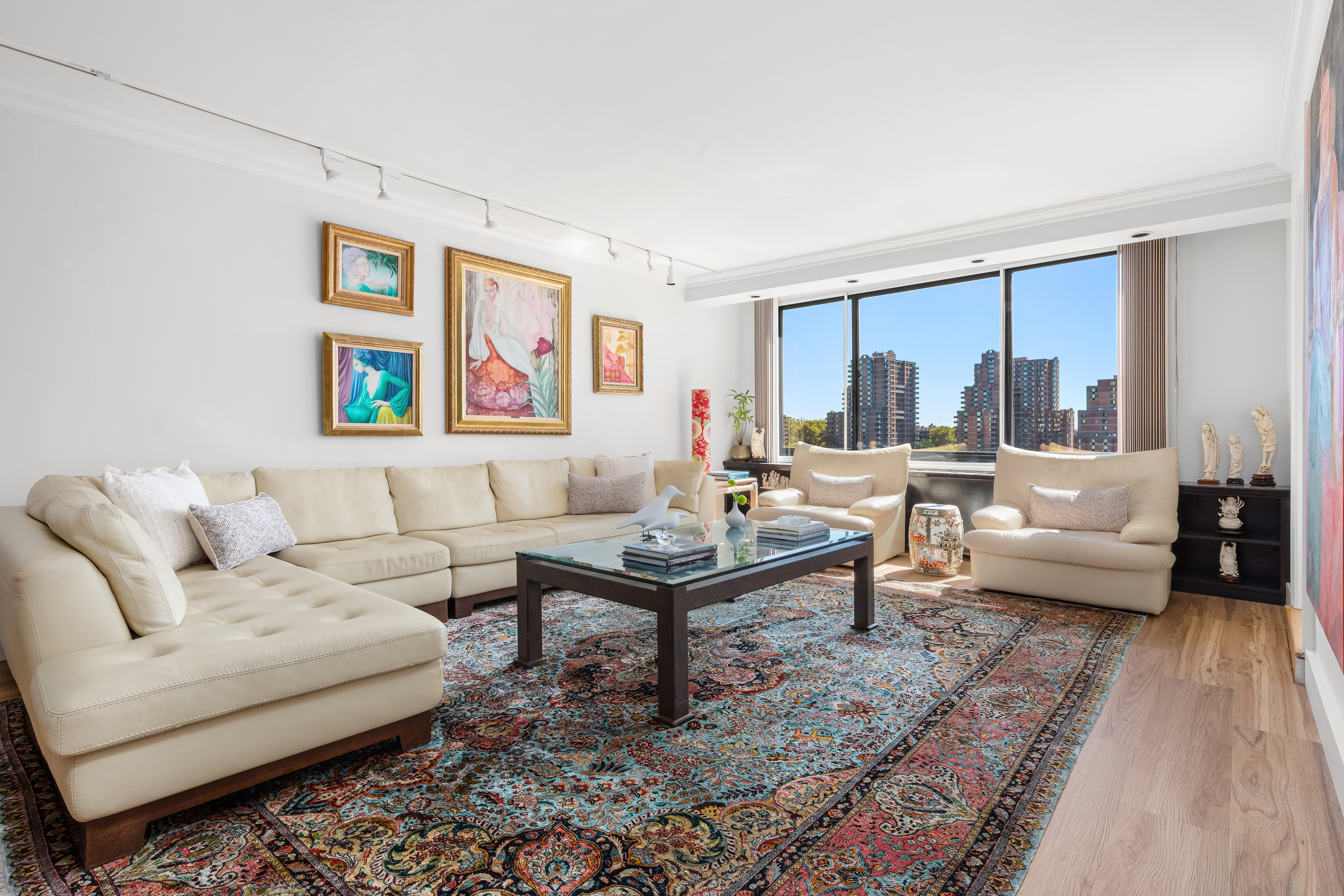 530 East 72nd Street, Unit 4F Manhattan, NY 10021 - Photo 3 of 23 a living room with furniture large window and a table