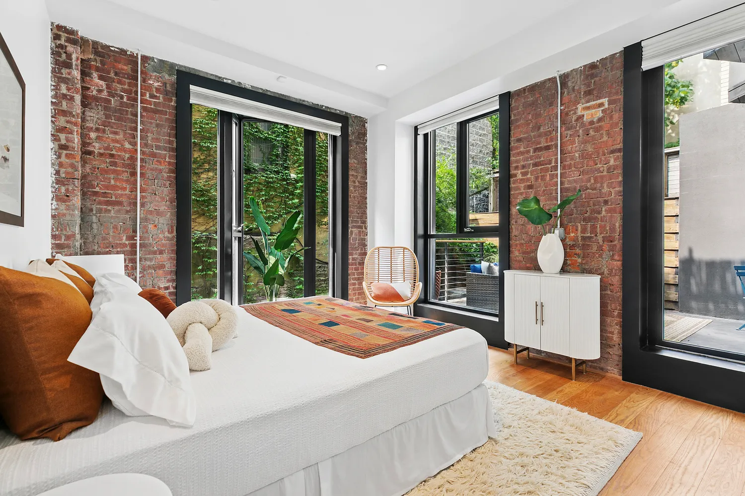 a bedroom with a large bed and a large window