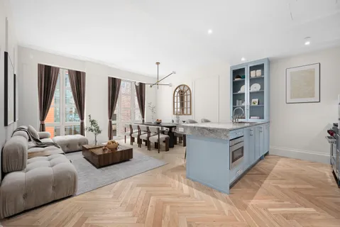 a living room with furniture and large windows