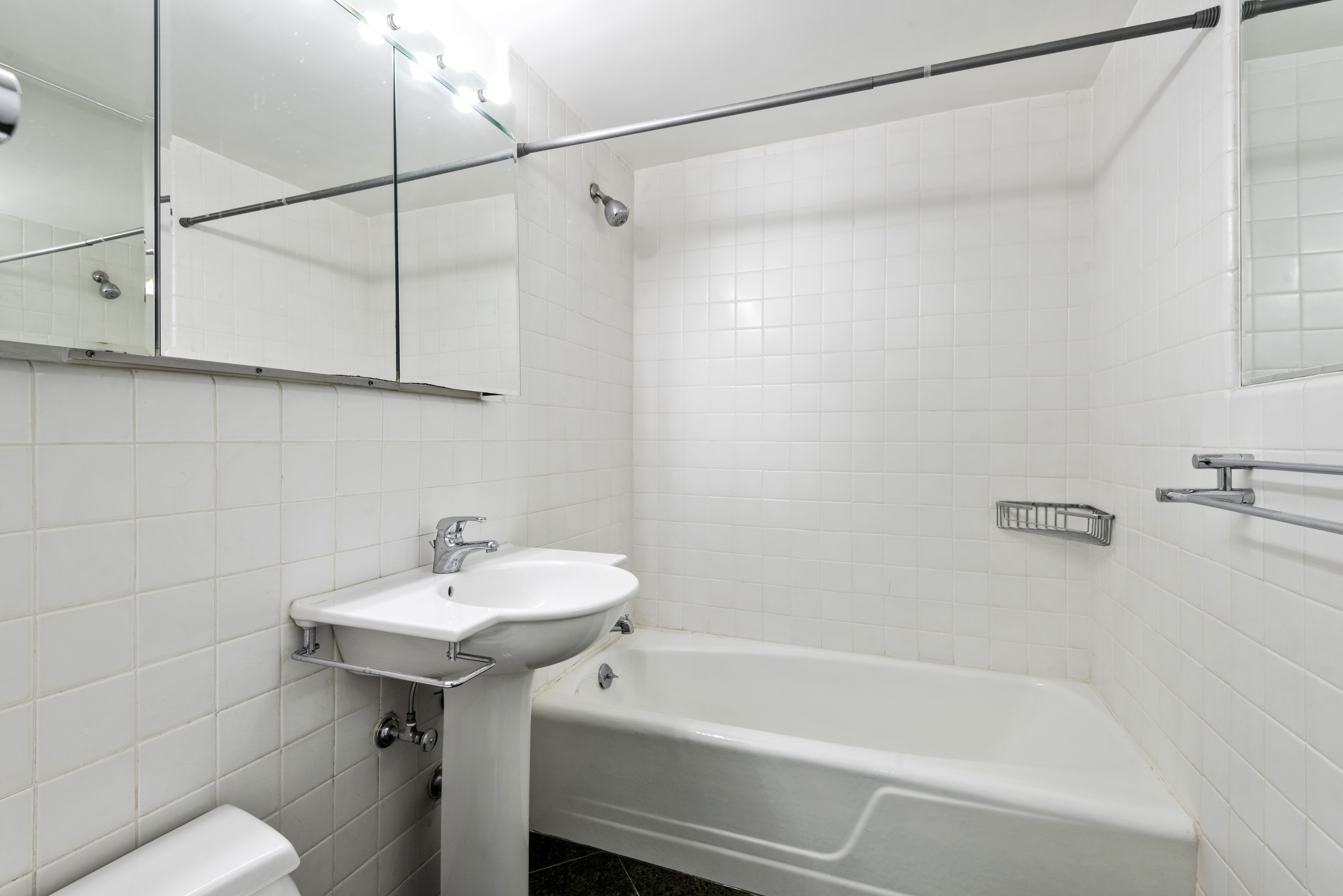 175 East 62nd Street, Unit 12A Manhattan, NY 10065 - Photo 14 of 24 a bathroom with a sink and a bathtub
