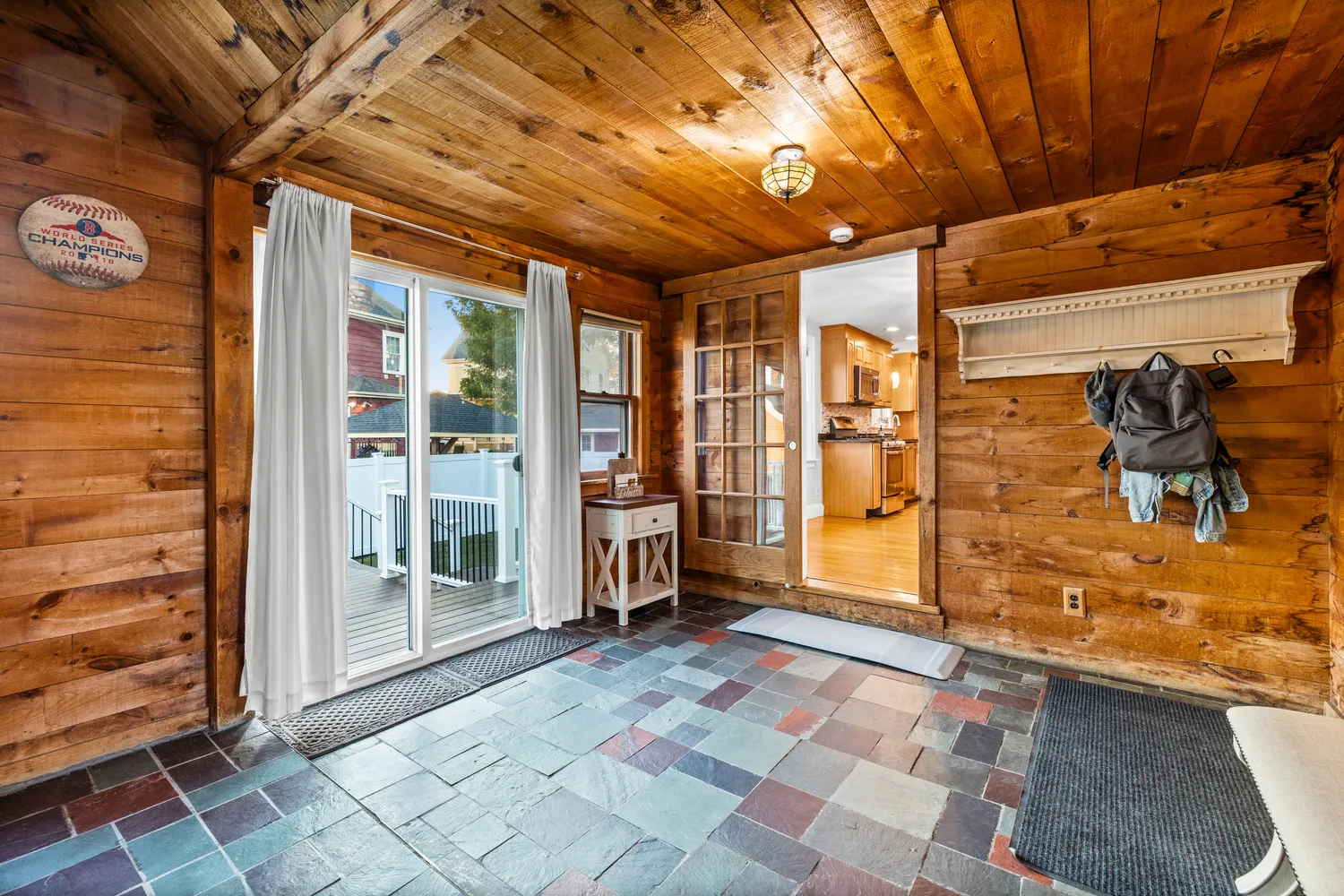 a view of empty room with wooden floor and windows