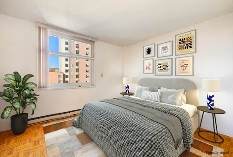 a bedroom with a large bed and a potted plant
