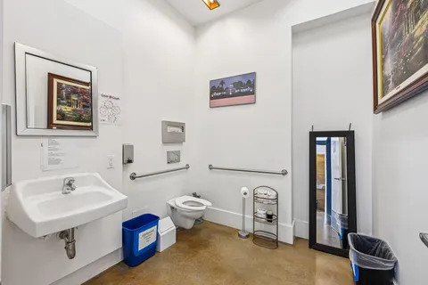 a bathroom with a sink toilet and a mirror