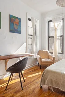 a bedroom with two beds and a large window