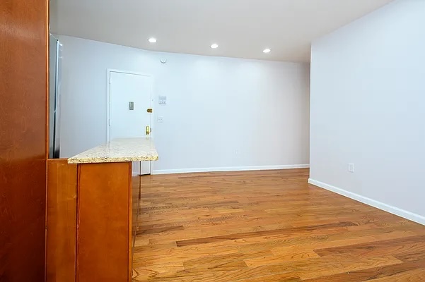 237 West 135th Street, Unit 3A Manhattan, NY 10030 - Photo 4 of 12 a view of an empty room with wooden floor