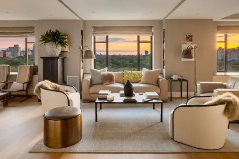 a living room with furniture and a floor to ceiling window