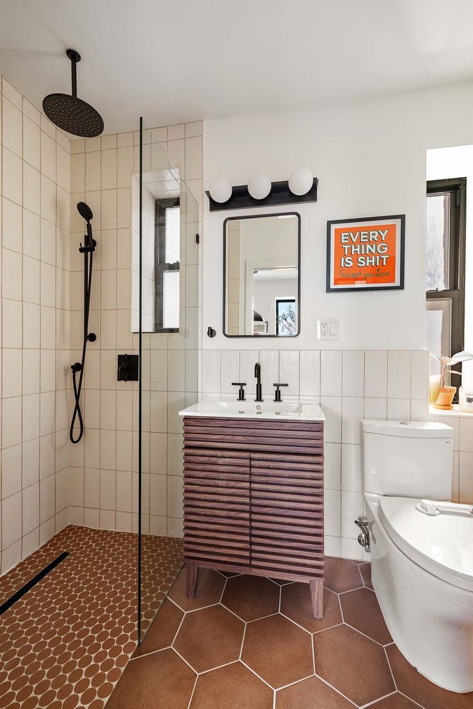 a bathroom with a sink a toilet and shower