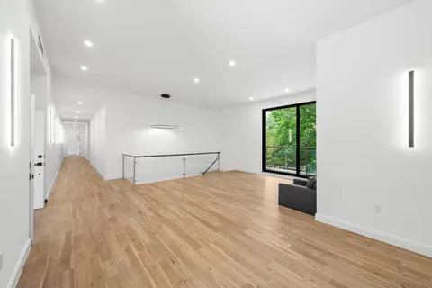 a large bedroom with a bed and a large window