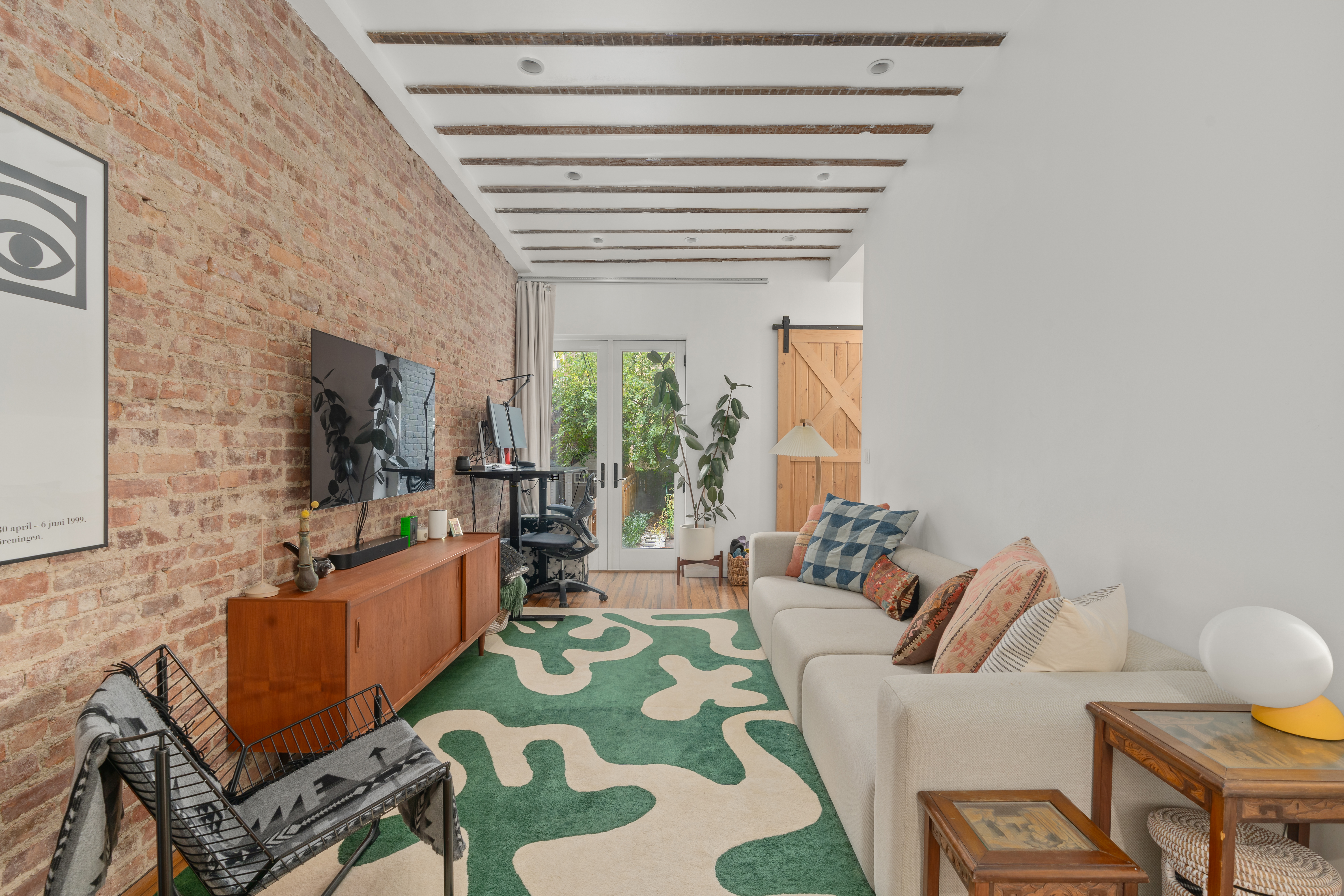 660 Saint Marks Avenue Brooklyn, NY 11216 - Photo 13 of 21 a living room with furniture and a flat screen tv