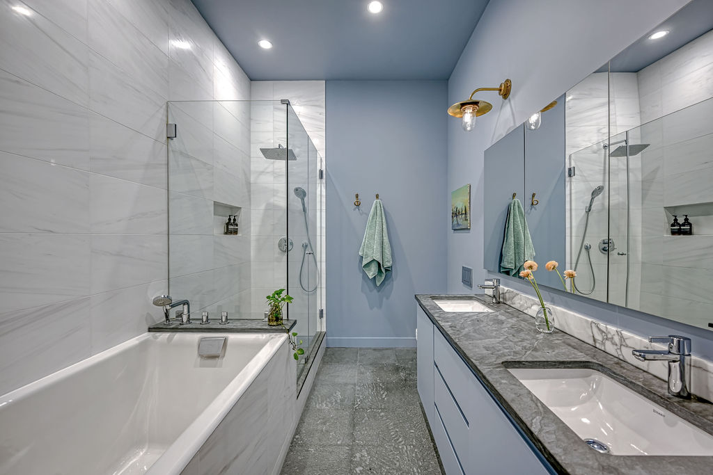 42 East 12th Street, Unit 2 Manhattan, NY 10003 - Photo 13 of 18 a bathroom with a granite countertop tub a sink and a large mirror