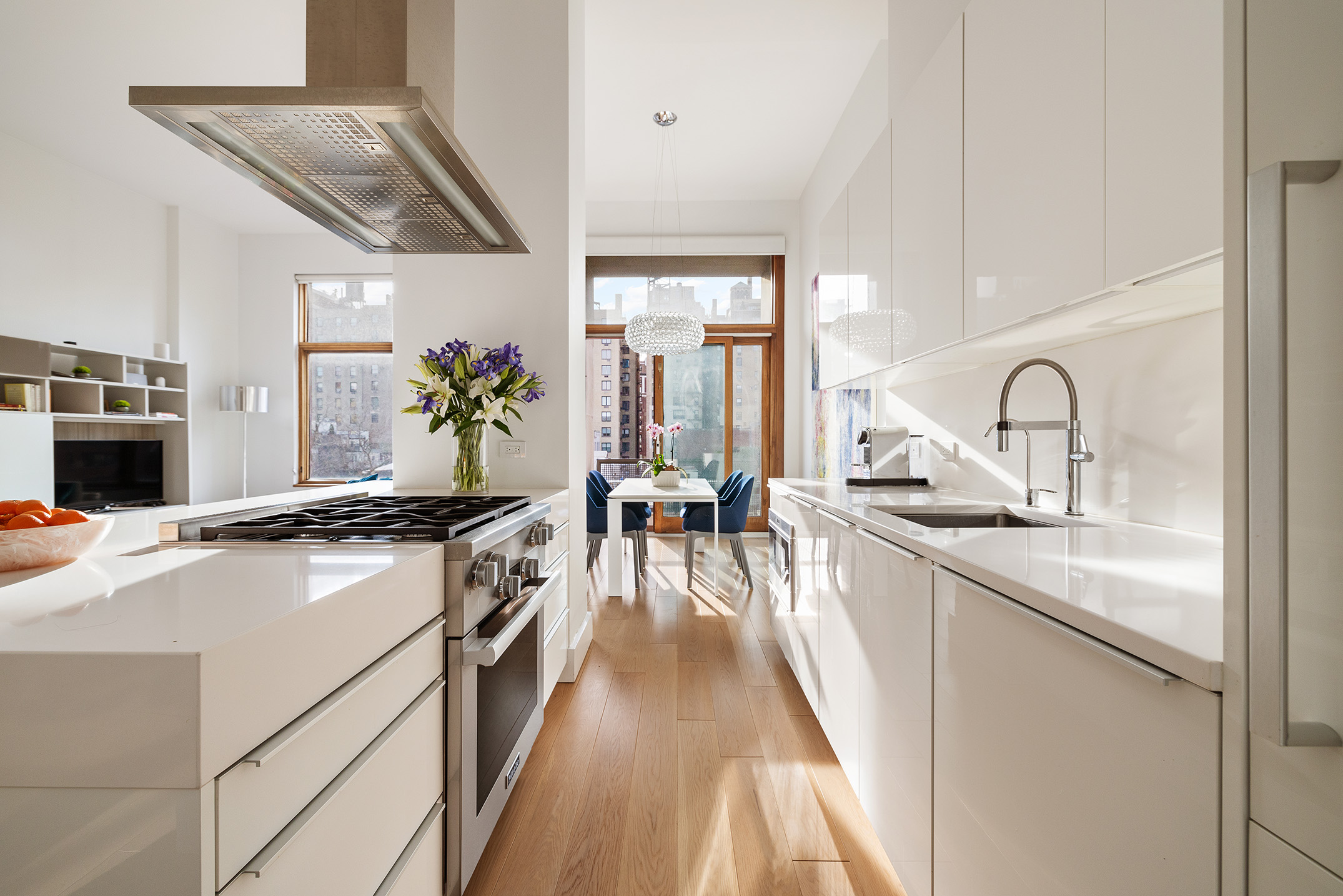 1080 Madison Avenue, Unit 6B Manhattan, NY 10028 - Photo 3 of 11 a large kitchen with stainless steel appliances granite countertop a lot of counter space and wooden floors