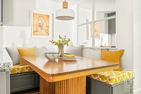 a dining room with furniture and window