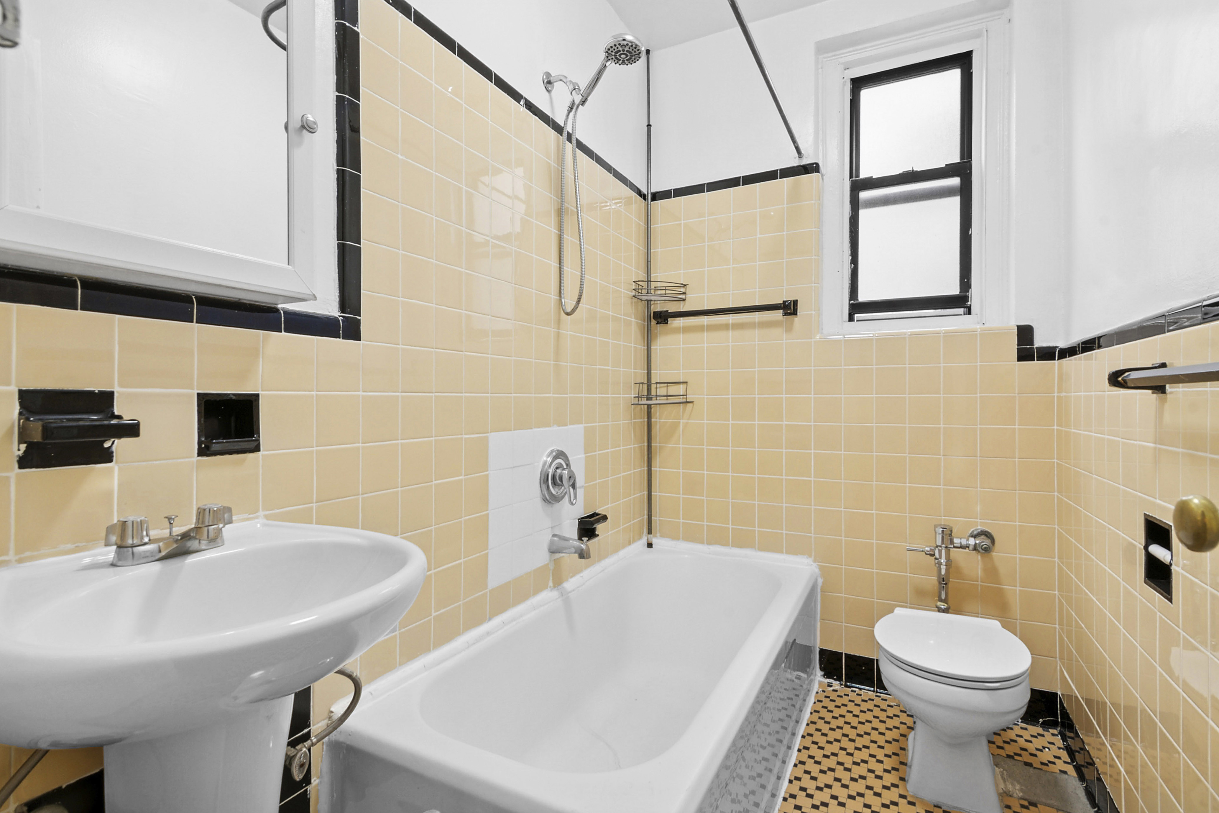 43-08 41st Street, Unit 5D Queens, NY 11104 - Photo 5 of 6 a bathroom with a sink toilet and shower