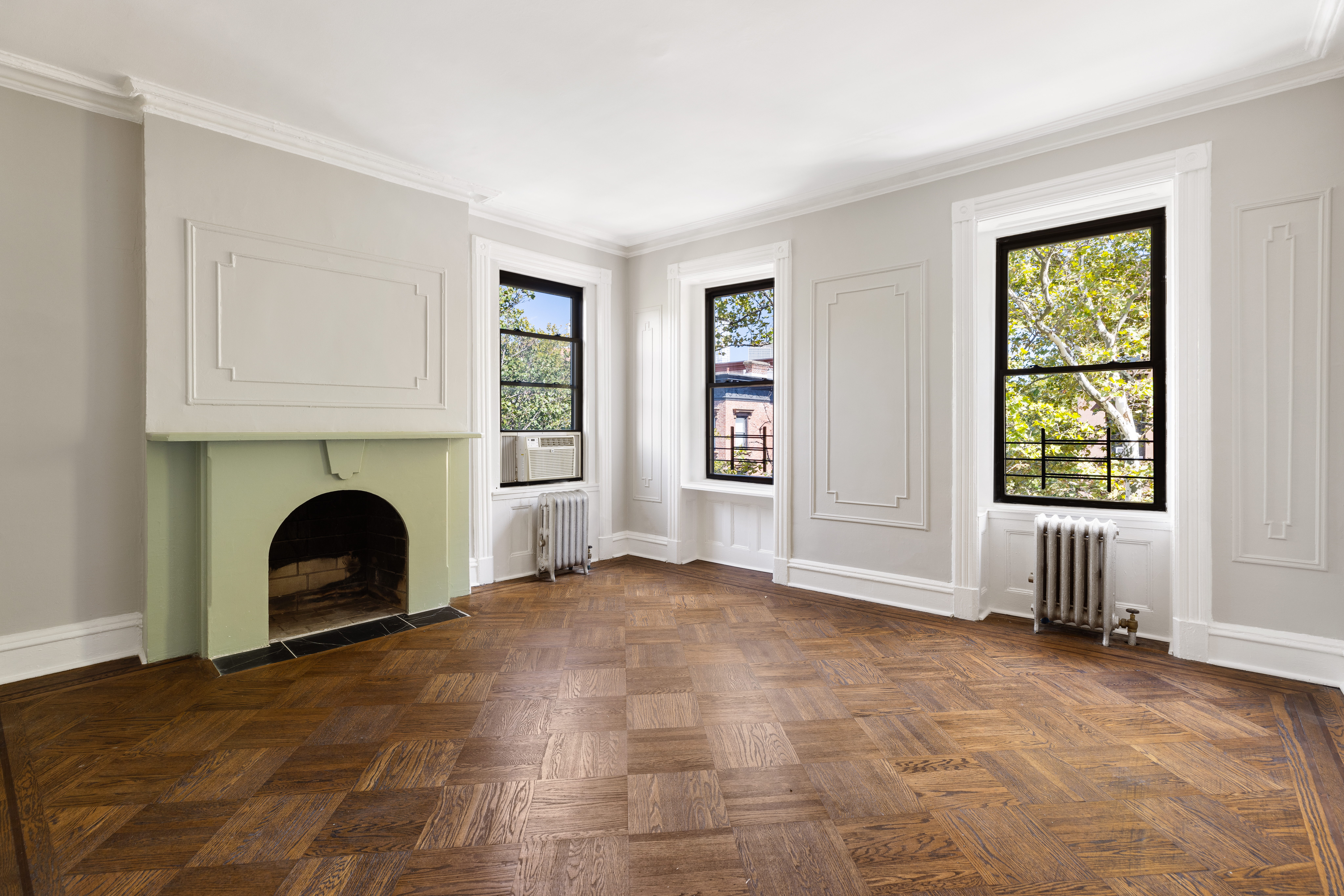 208 Warren Street Brooklyn, NY 11201 - Photo 4 of 10 an empty room with windows and fireplace