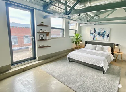 a view of a room with wooden floor and windows