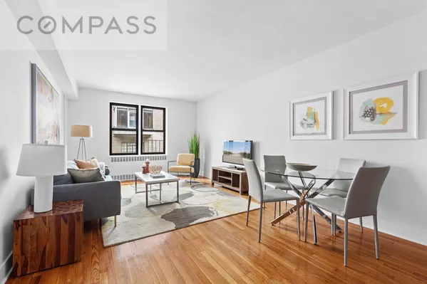 a living room with furniture wooden floor and a window