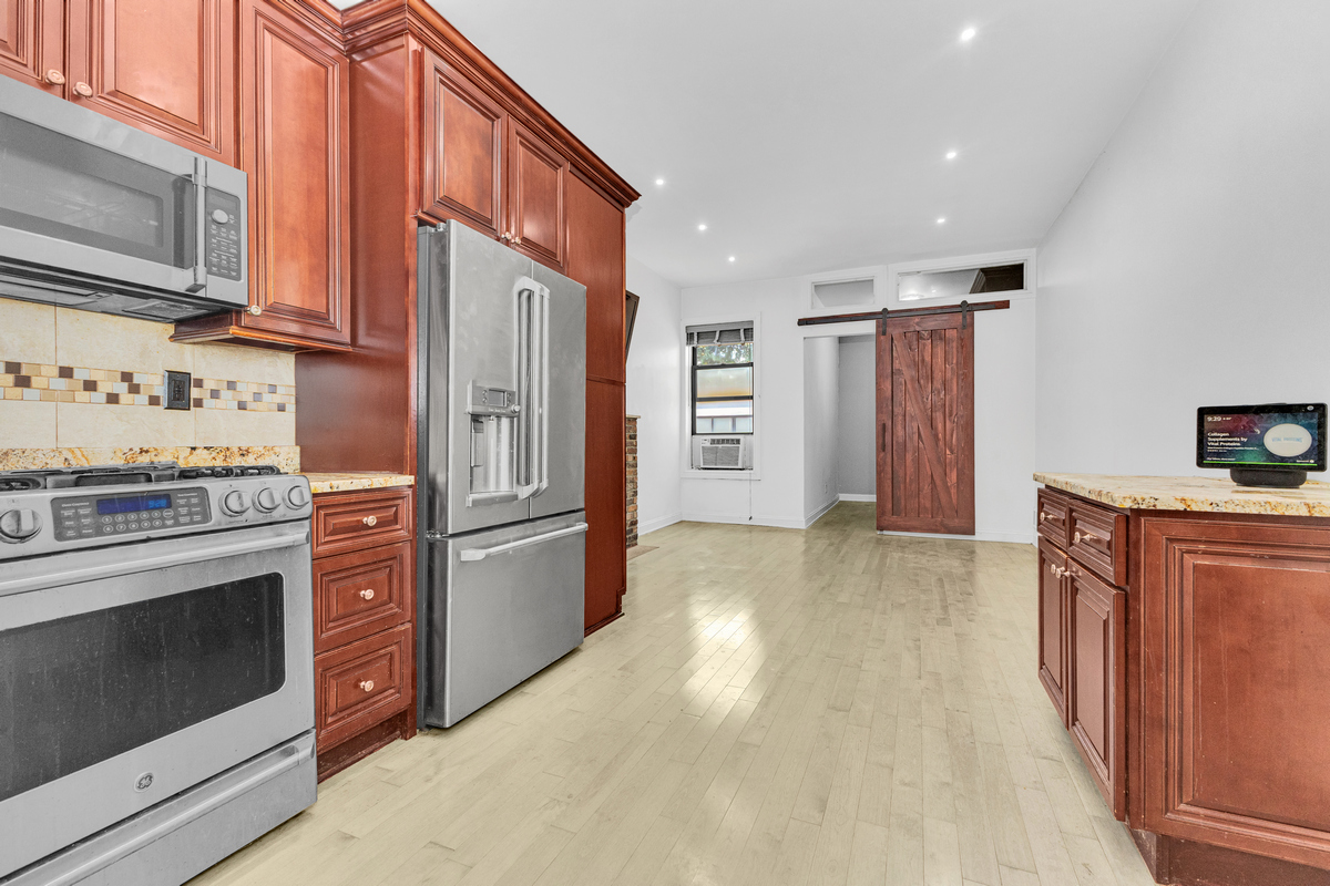 521 Dean Street, Unit 4L Brooklyn, NY 11217 - Photo 7 of 17 a kitchen with stainless steel appliances granite countertop a refrigerator stove and sink