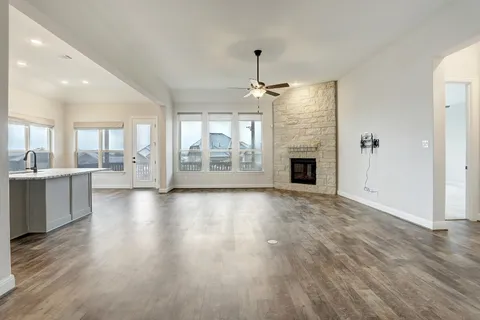 an empty room with wooden floor and outdoor view