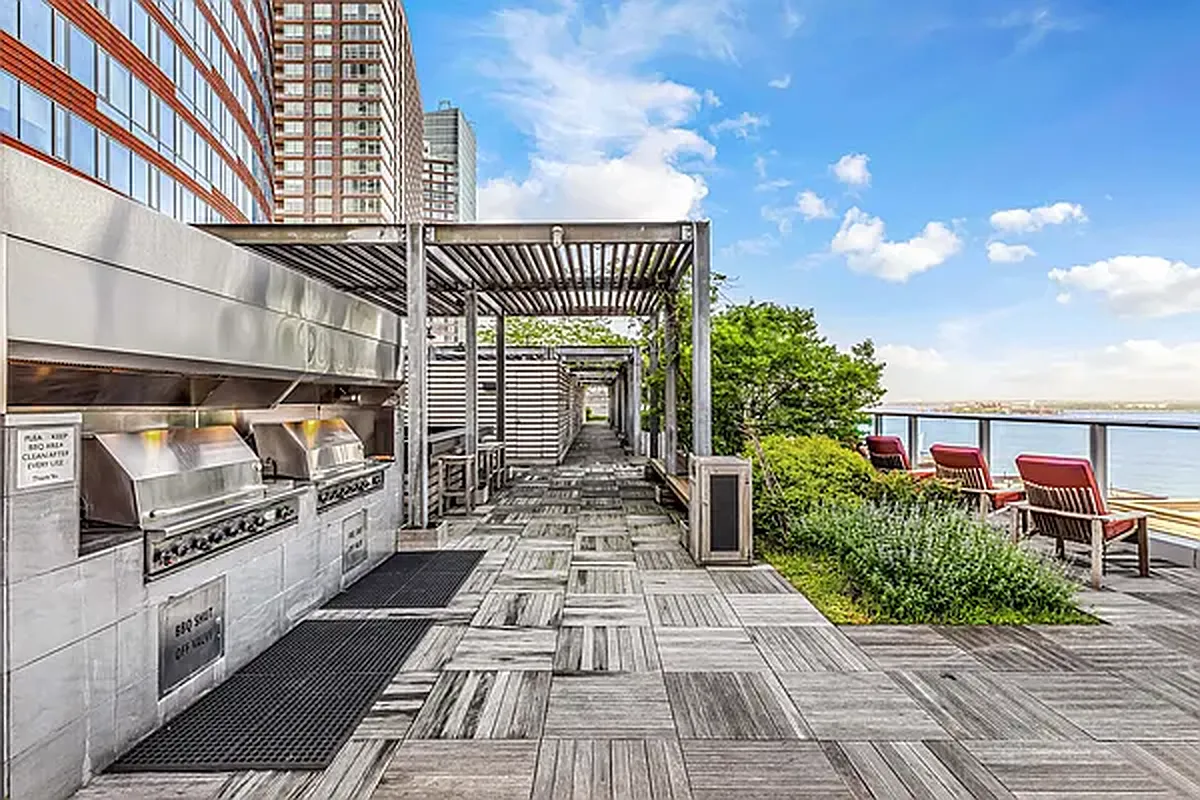 70 Little West Street, Unit 15A Manhattan, NY 10004 - Photo 12 of 19 a view of a patio with table and chairs with wooden floor
