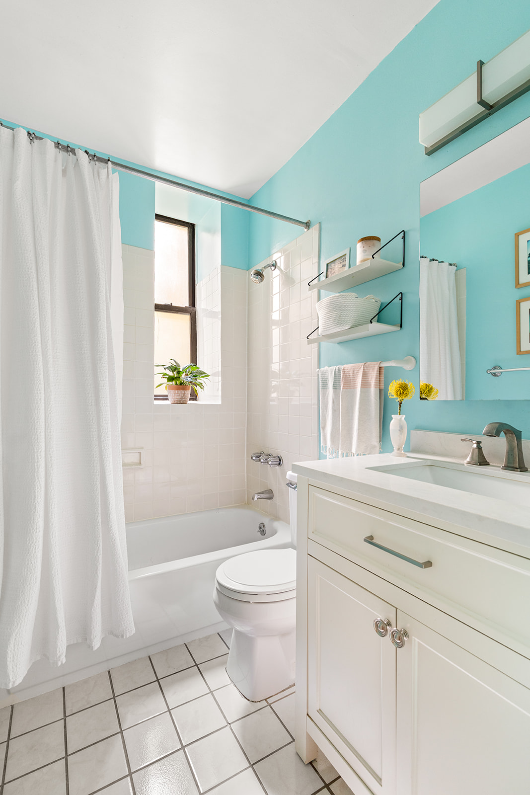 295 St Johns Place, Unit 1C Brooklyn, NY 11238 - Photo 10 of 17 a bathroom with a sink a toilet and a shower curtain