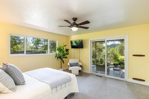 a bedroom with a balcony a bed and a chandelier