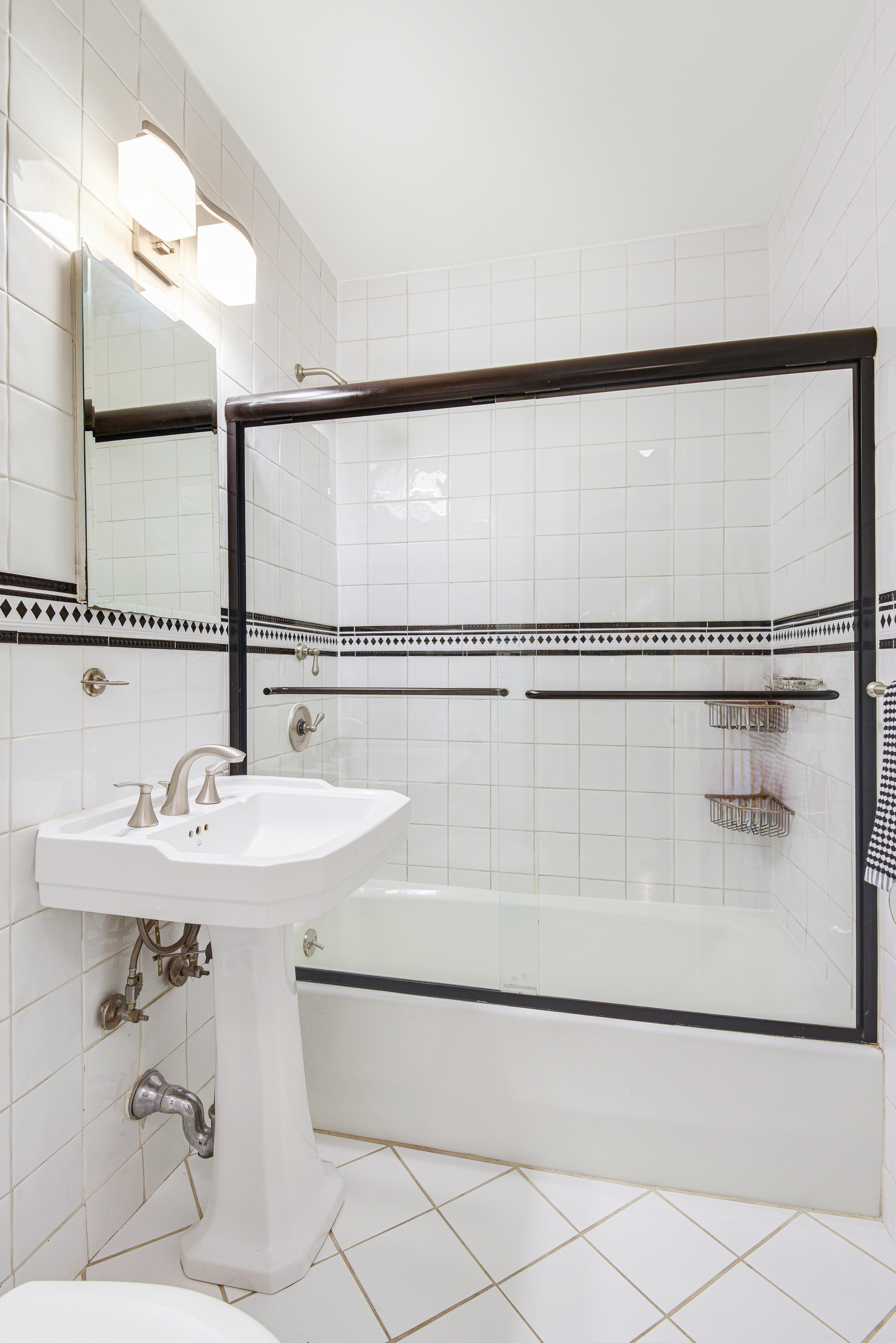 321 West 90th Street, Unit 2F Manhattan, NY 10024 - Photo 12 of 16 a bathroom with a sink and mirror