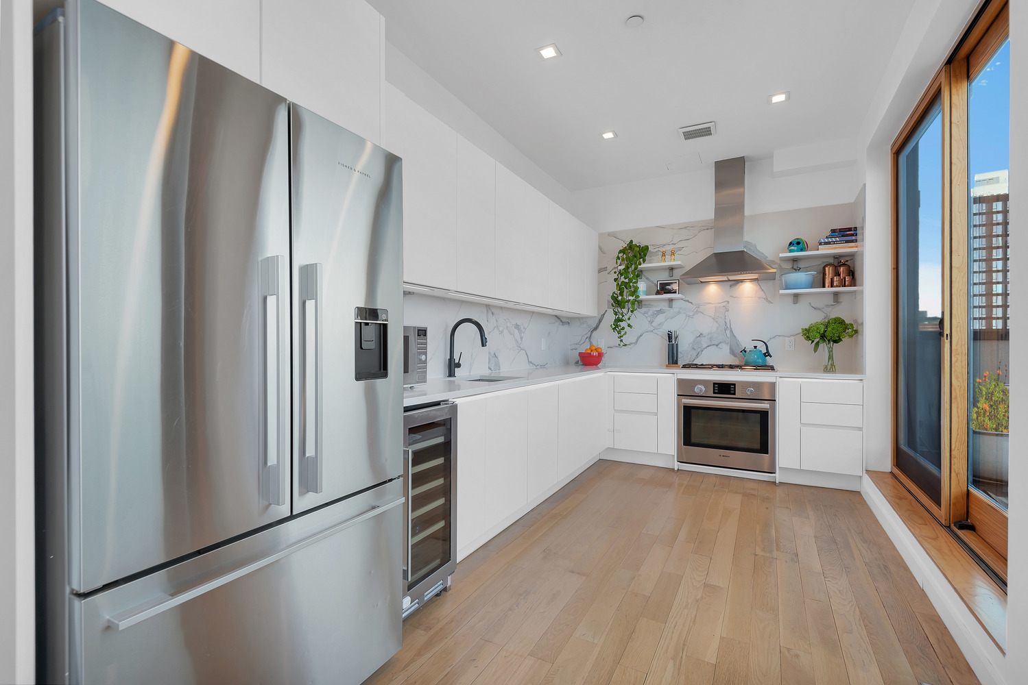 267 Evergreen Avenue, Unit PH Brooklyn, NY 11221 - Photo 4 of 19 a kitchen with stainless steel appliances a refrigerator sink and stove