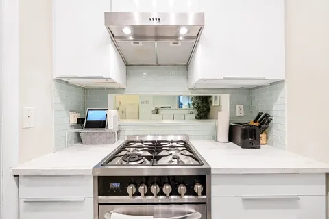 a kitchen with a stove and cabinets