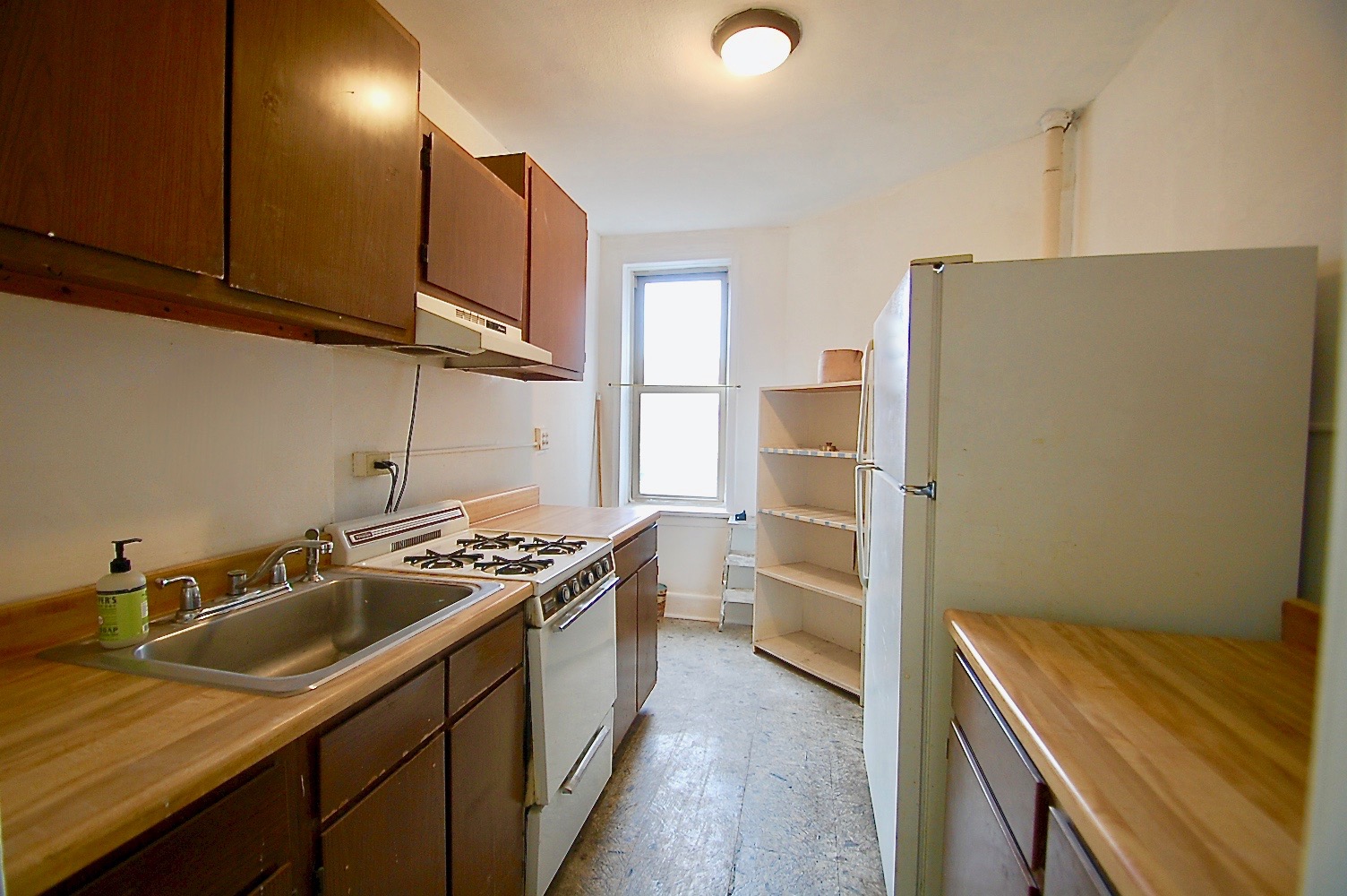 43-10 48th Avenue, Unit 2P Queens, NY 11377 - Photo 3 of 9 a kitchen that has a sink a stove and a refrigerator