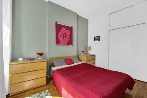 a bedroom with a bed and a dresser