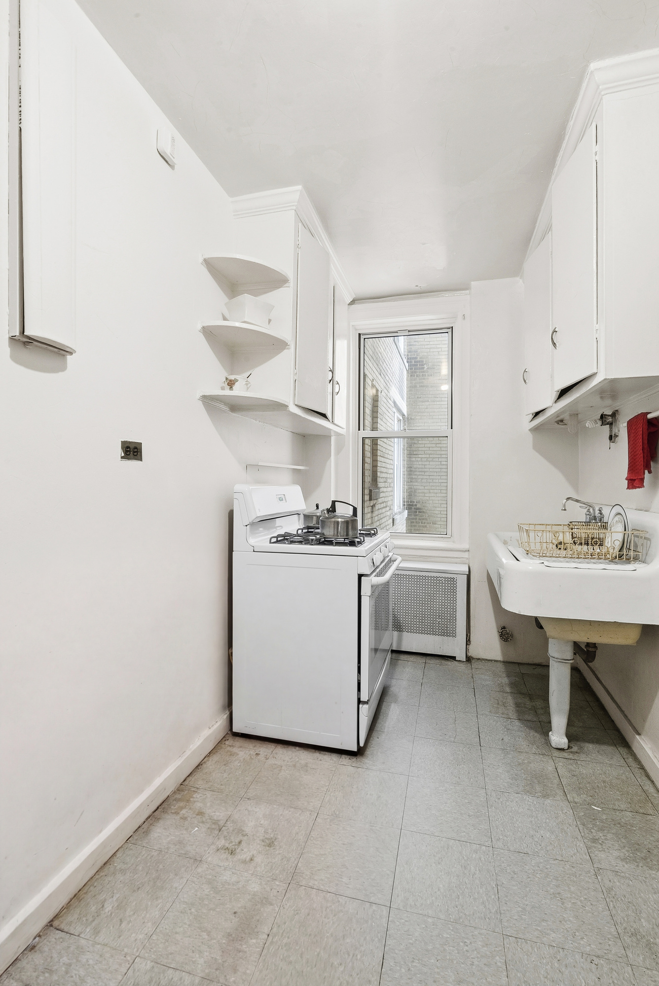 12 West 96th Street, Unit 9A Manhattan, NY 10025 - Photo 8 of 14 a view of kitchen with cabinets and window