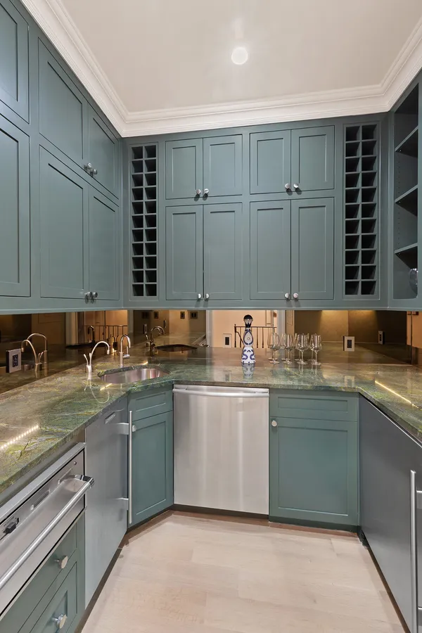 a large kitchen with a sink and cabinets