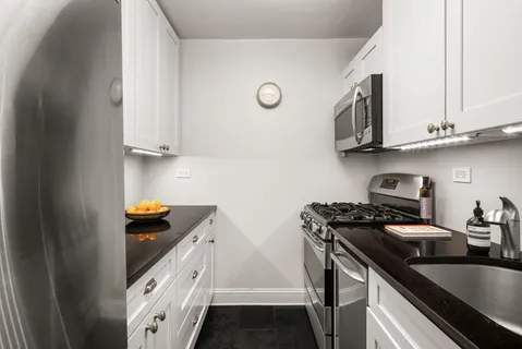 a kitchen with stainless steel appliances granite countertop a stove and a sink