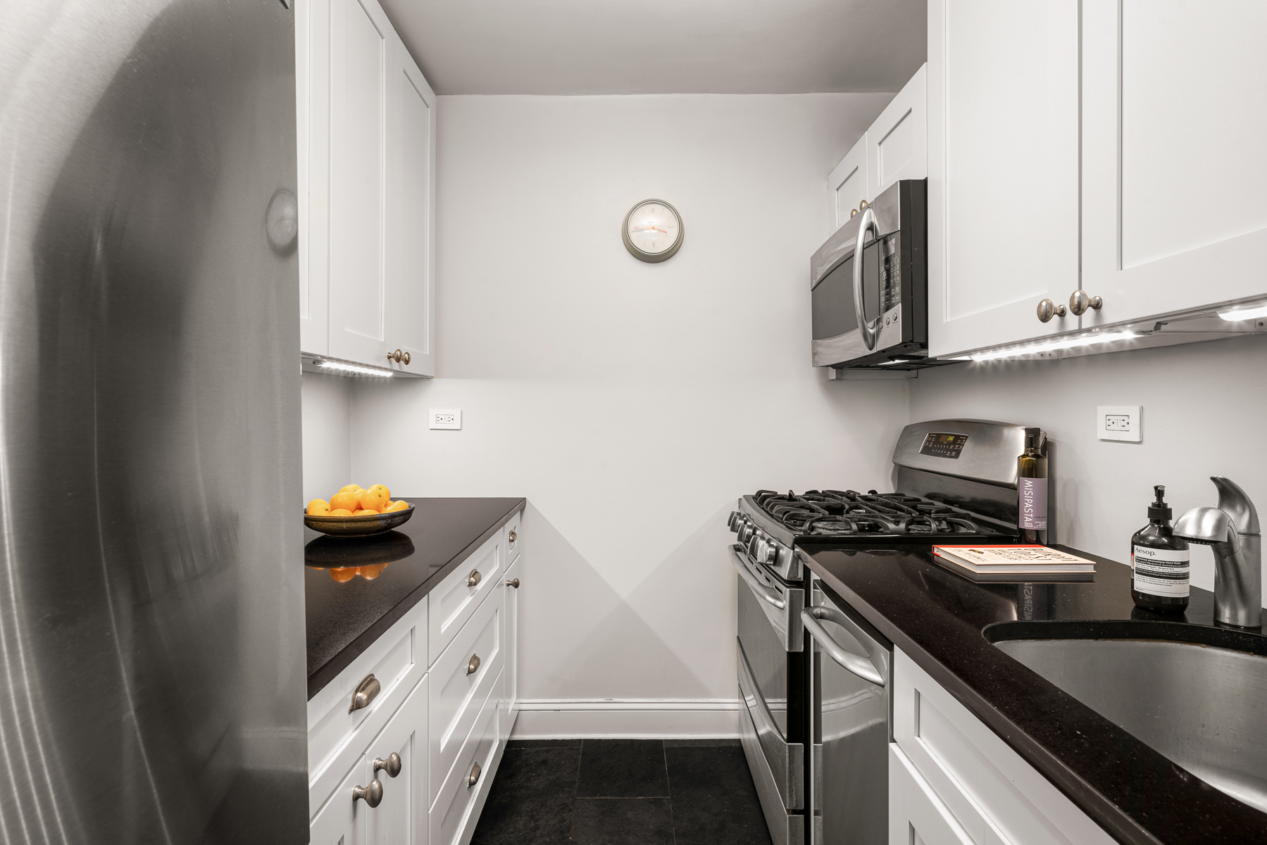 150 West End Avenue, Unit 24S Manhattan, NY 10023 - Photo 6 of 14 a kitchen with stainless steel appliances granite countertop a stove and a sink