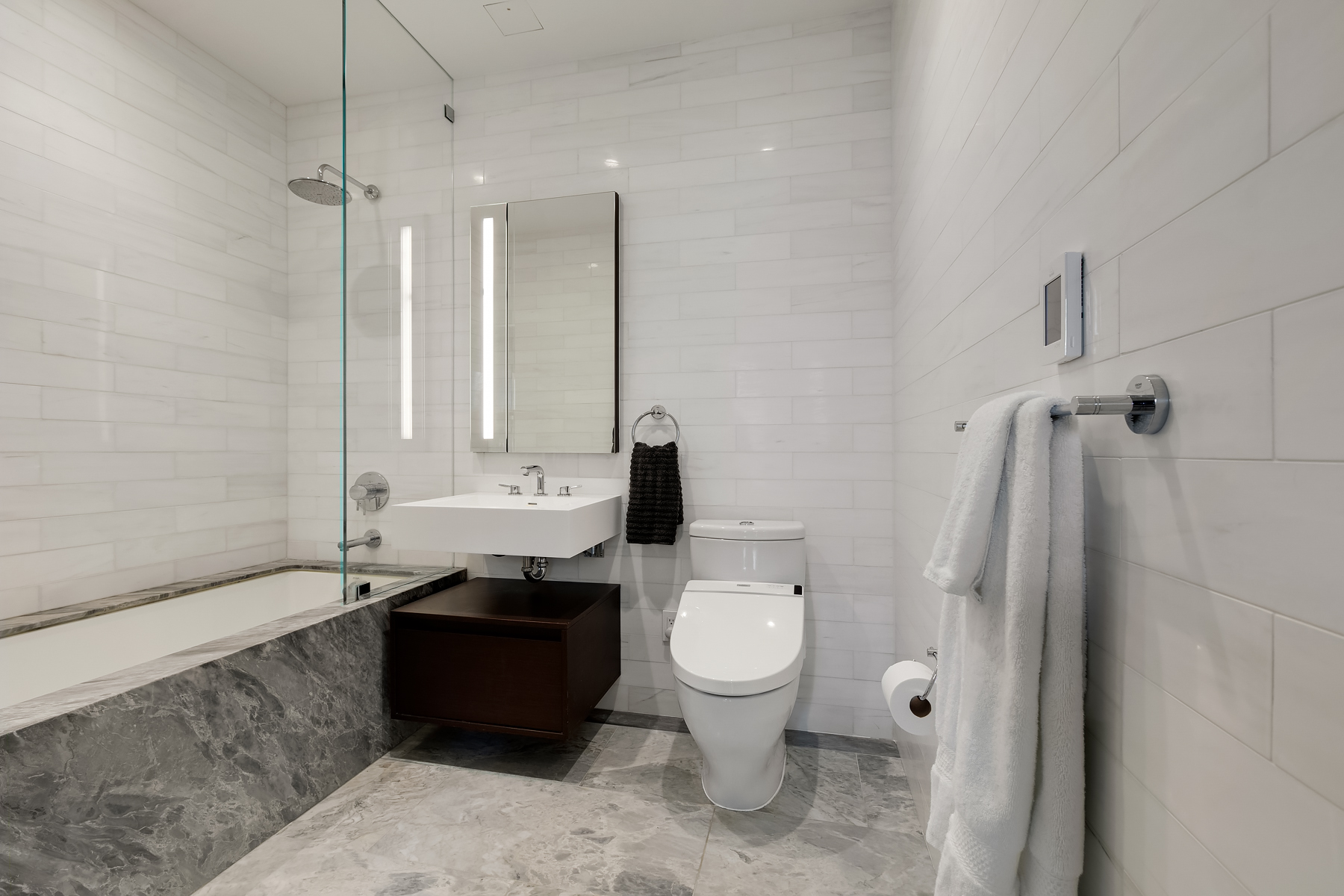 287 East Houston Street, Unit 4C Manhattan, NY 10002 - Photo 4 of 12 a bathroom with a granite countertop sink toilet and shower