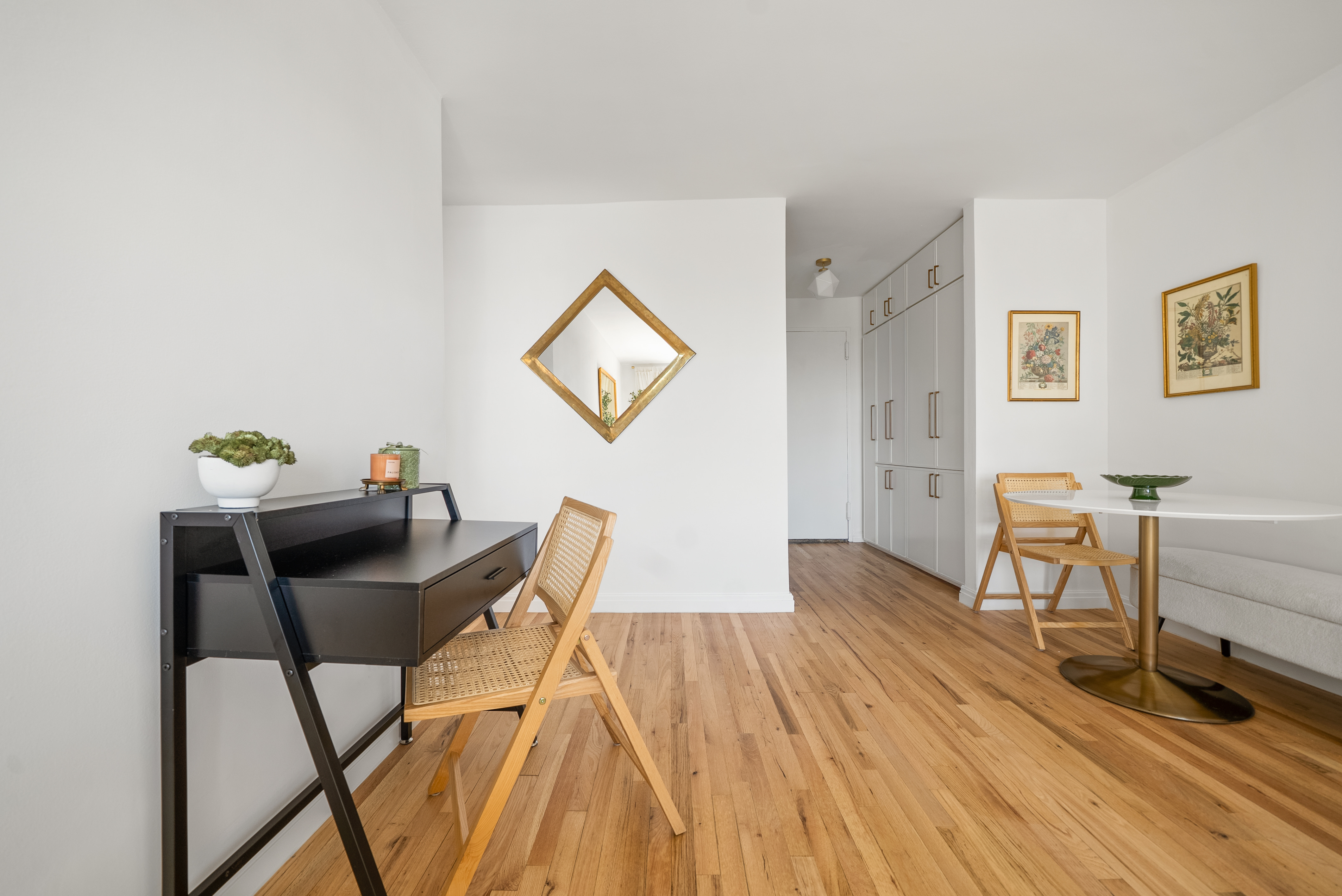 165 Christopher Street, Unit 6DD Manhattan, NY 10014 - Photo 4 of 8 a workspace room with furniture and wooden floor