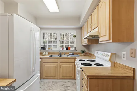 a kitchen with stainless steel appliances a stove a sink and a microwave