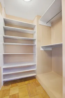 a view of walk in closet with empty racks