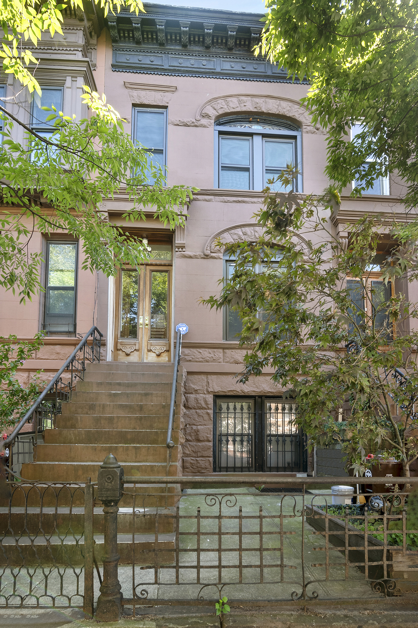 698 Halsey Street Brooklyn, NY 11233 - Photo 12 of 13 front view of a house with a small yard