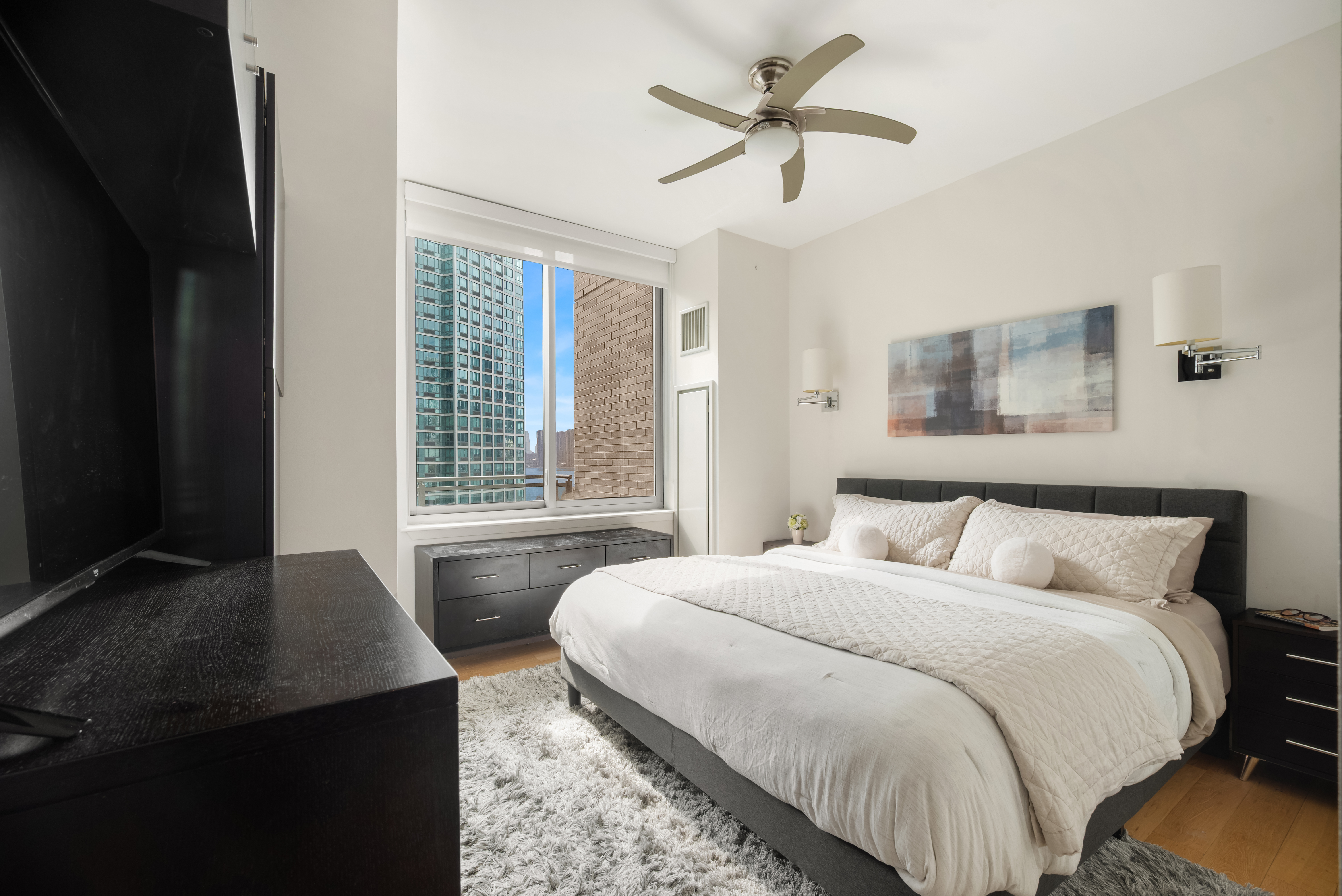 46-30 Center Boulevard, Unit 707 Queens, NY 11109 - Photo 7 of 23 a bedroom with bed and window